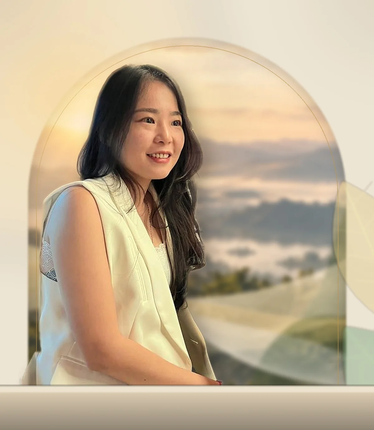 Rena Tan, smiling, in a sunlit garden pavilion